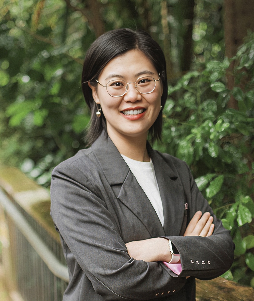 Portrait of Zoey Sun smiling, standing among native bush
